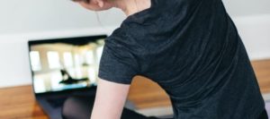 Woman practising Yoga poses online